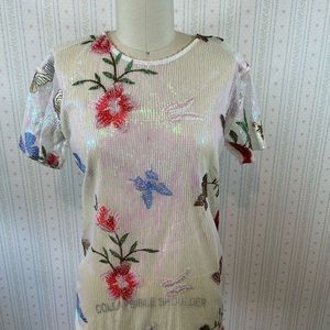 Sheer iridescent opal sequin top with embroidered flowers and butterflies.